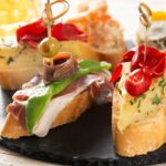 imgi_28_assortment-spanish-pintxos-wooden-table-typical-spanish-food_123827-21692