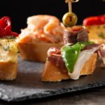 imgi_43_assortment-spanish-pintxos-wooden-table-typical-spanish-food_123827-21819